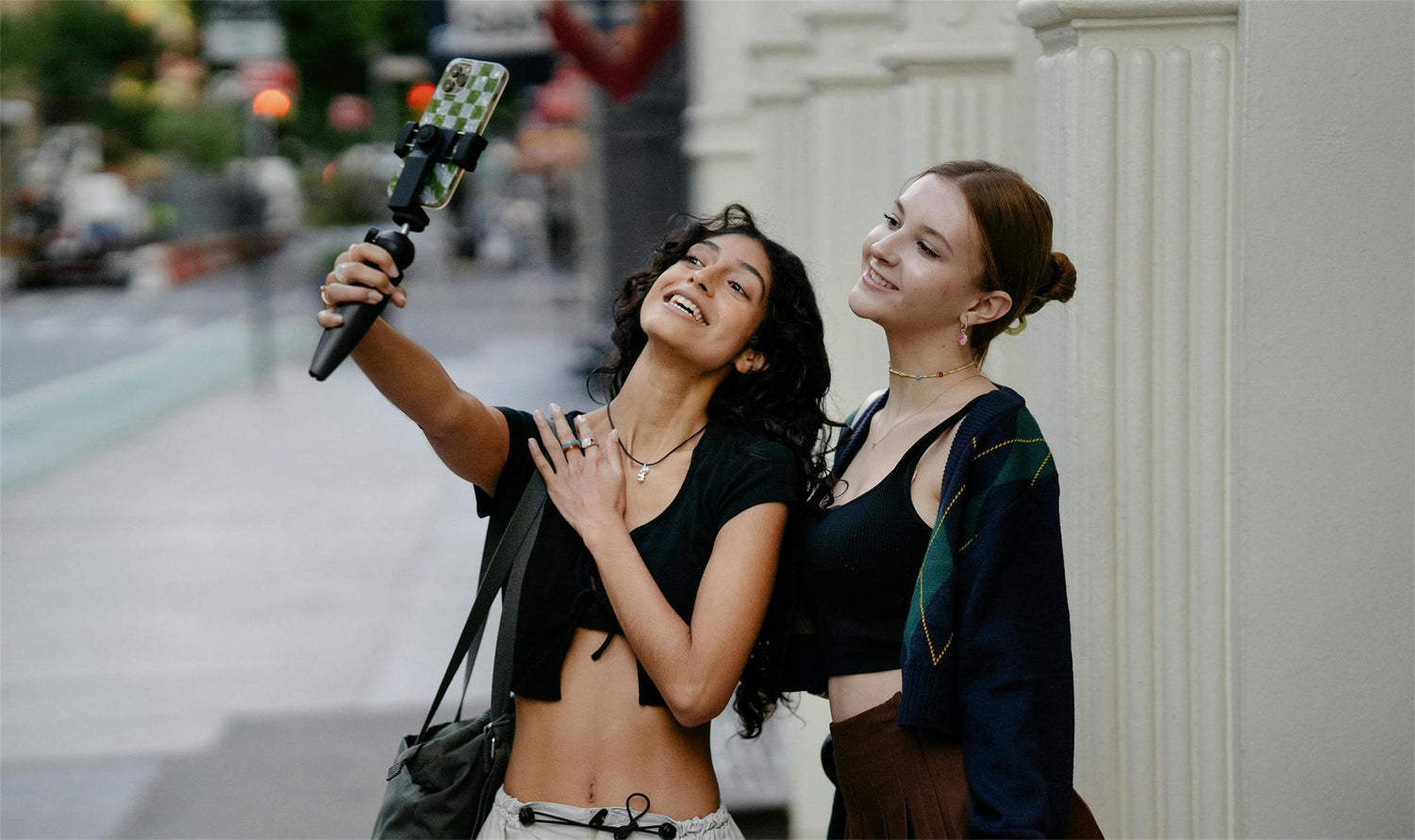  Influencers capturing a moment with an Apexel camera handle on the street.